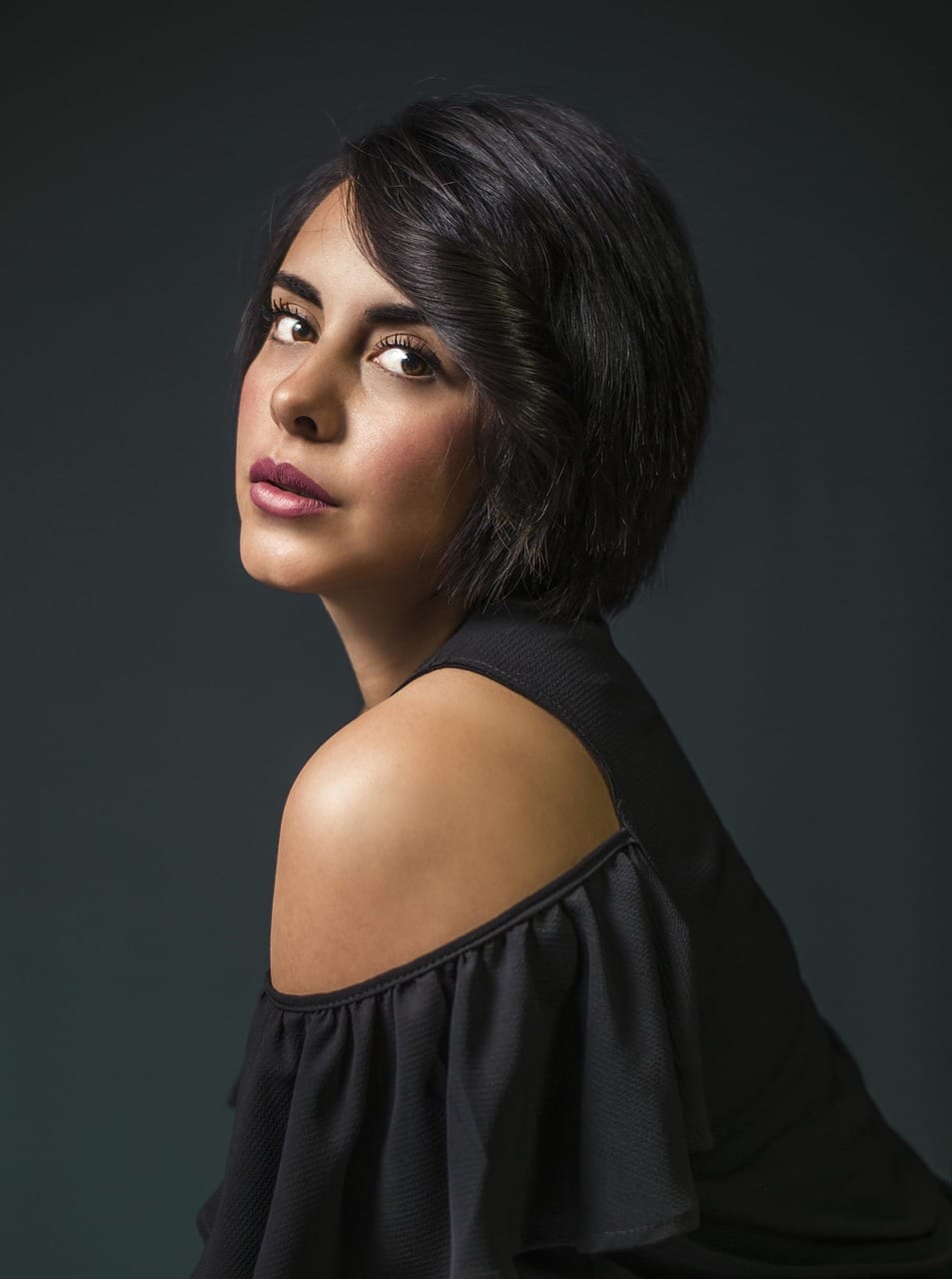 At Maison Verel, black crepe and a bare shoulder.