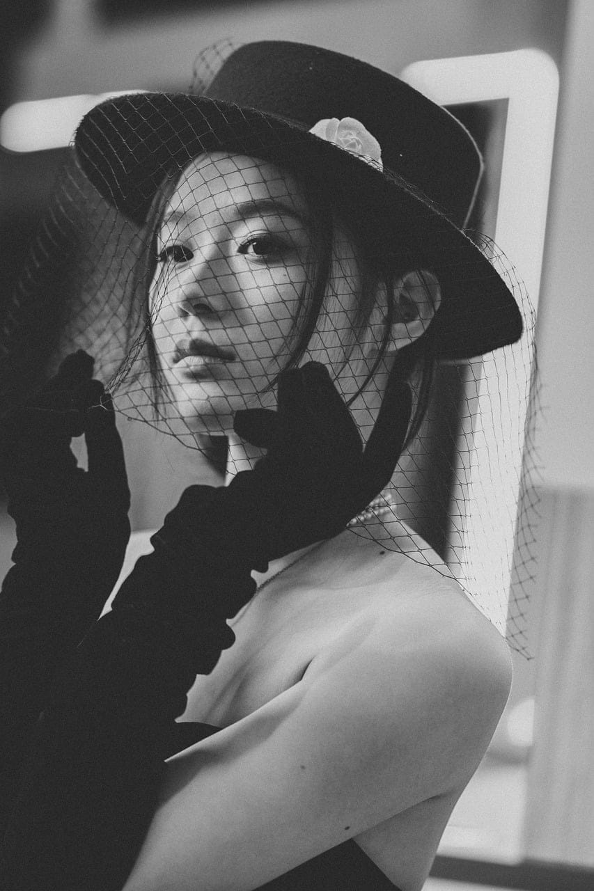 A wide felt hat at Delacour, in the same grey as the coat.
